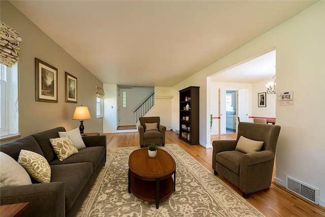 1445 Stanley Dr, Penn Hills, PA 15147 - living area featuring wood finished floors, stairway, and a chandelier
