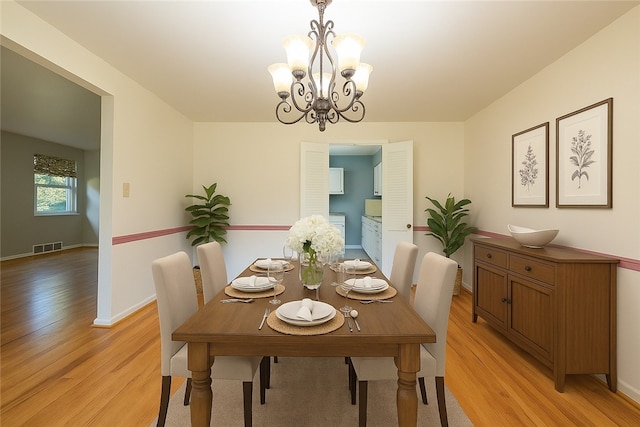 1445 Stanley Dr, Penn Hills, PA 15147 - dining space with light wood-style floors and a chandelier