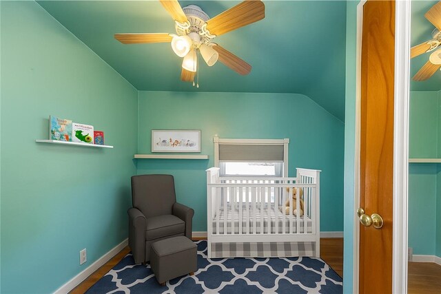 1445 Stanley Dr, Penn Hills, PA 15147 - bedroom featuring lofted ceiling, wood finished floors, a nursery area, and a ceiling fan