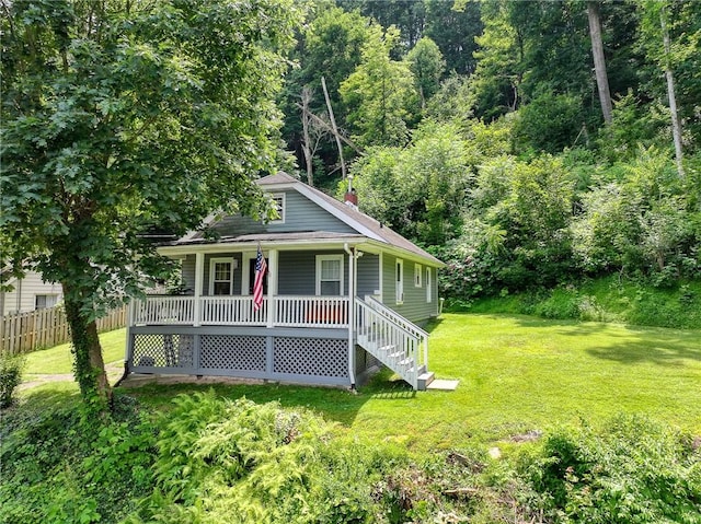 108 Hird Rd, Trafford, PA 15085 - bungalow with covered porch, a chimney, a wooded view, and a shingled roof