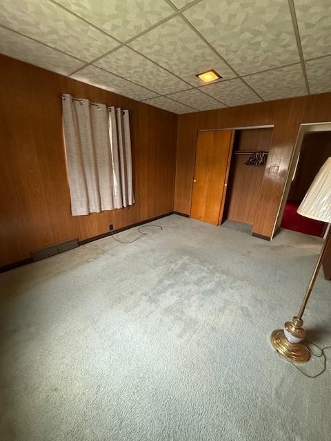 410 Hershey Rd, Penn Hills, PA 15235 - spare room featuring a drop ceiling and wood walls