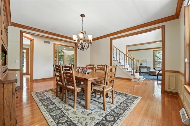 1023 Sophia Ln, Adams Twp, PA 16046 - dining area with ornamental molding, stairway, a chandelier, and light wood-type flooring