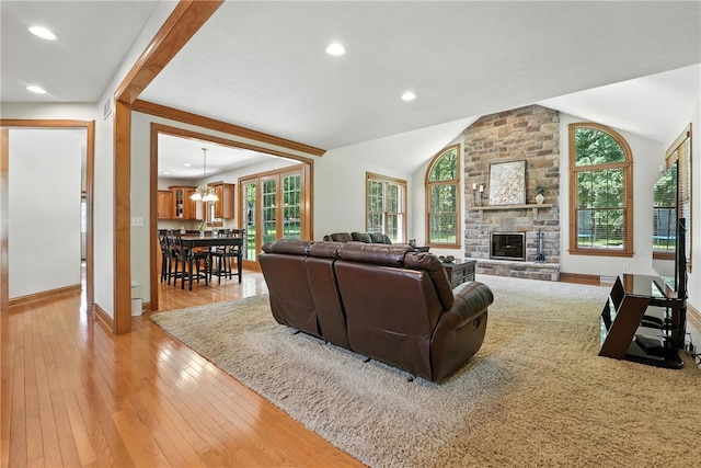 1023 Sophia Ln, Adams Twp, PA 16046 - living room featuring plenty of natural light, light wood finished floors, vaulted ceiling, a stone fireplace, and recessed lighting