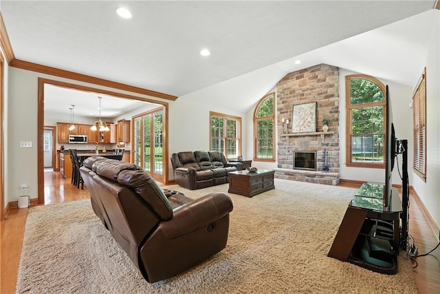 1023 Sophia Ln, Adams Twp, PA 16046 - living room featuring light wood-type flooring, lofted ceiling, a stone fireplace, recessed lighting, and a chandelier