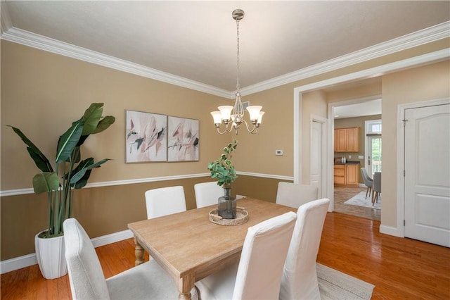 2214 Shannon Mills Dr, Connoquenessing Twp, PA 16053 - dining area with a chandelier, crown molding, and light wood-type flooring