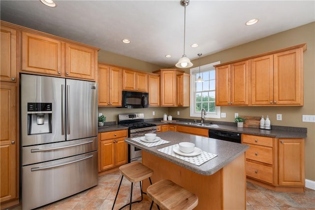 2214 Shannon Mills Dr, Connoquenessing Twp, PA 16053 - kitchen featuring black appliances, recessed lighting, a center island, dark countertops, and a kitchen breakfast bar