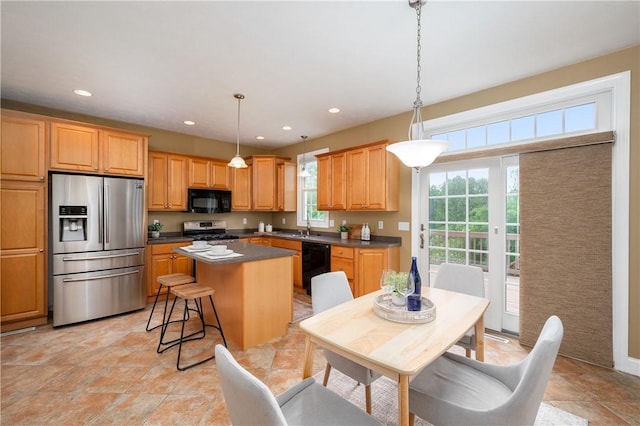2214 Shannon Mills Dr, Connoquenessing Twp, PA 16053 - kitchen featuring black appliances, dark countertops, a center island, light stone finish floors, and decorative light fixtures
