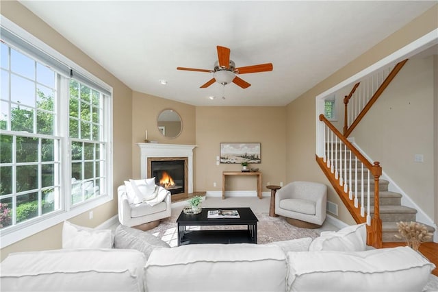 2214 Shannon Mills Dr, Connoquenessing Twp, PA 16053 - living area featuring stairs, a ceiling fan, and a glass covered fireplace