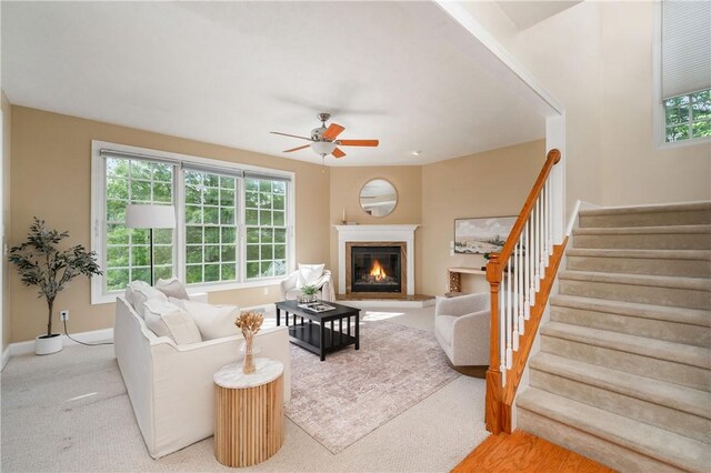 2214 Shannon Mills Dr, Connoquenessing Twp, PA 16053 - carpeted living room featuring a ceiling fan, stairs, and a glass covered fireplace
