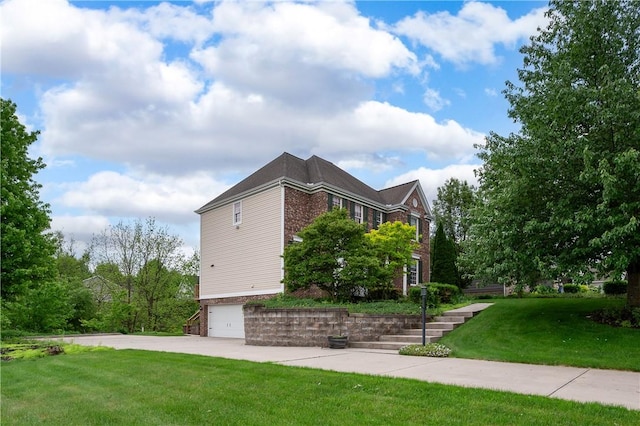 2214 Shannon Mills Dr, Connoquenessing Twp, PA 16053 - view of side of home with brick siding, a garage, a yard, and driveway