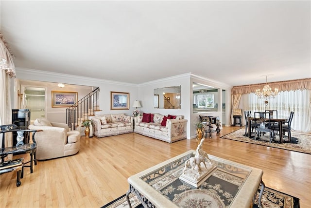 145 Herbst Rd, Kennedy Twp, PA 15108 - living area with a chandelier, wood finished floors, healthy amount of natural light, and crown molding