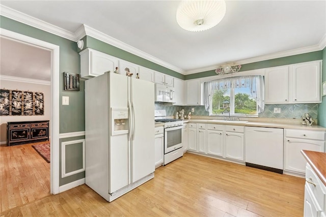 145 Herbst Rd, Kennedy Twp, PA 15108 - kitchen featuring white appliances, light wood-style floors, white cabinets, decorative backsplash, and ornamental molding