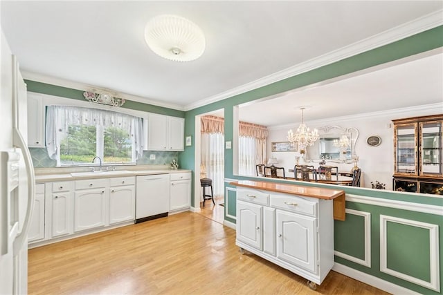 145 Herbst Rd, Kennedy Twp, PA 15108 - kitchen with white dishwasher, white cabinets, light wood finished floors, light countertops, and backsplash