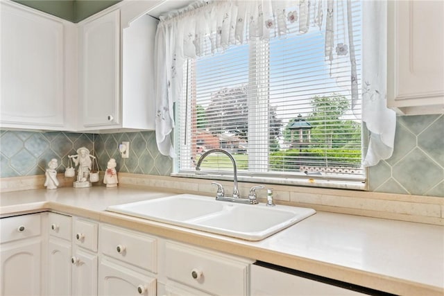 145 Herbst Rd, Kennedy Twp, PA 15108 - kitchen featuring white cabinetry, light countertops, backsplash, and white dishwasher