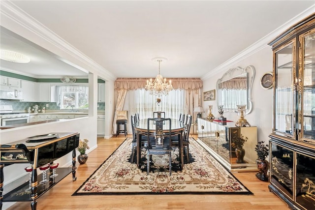 145 Herbst Rd, Kennedy Twp, PA 15108 - dining area with a chandelier, light wood-style flooring, and crown molding