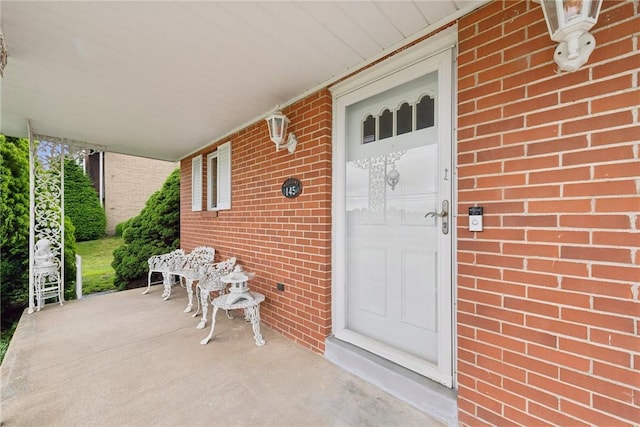145 Herbst Rd, Kennedy Twp, PA 15108 - view of exterior entry featuring brick siding and covered porch