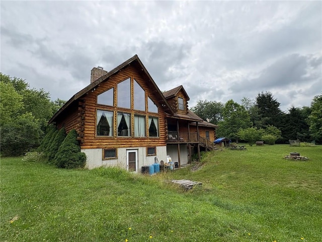 1530 Washington Rd, Washington Twp, PA 15613 - rear view of house with a chimney, a lawn, and log siding