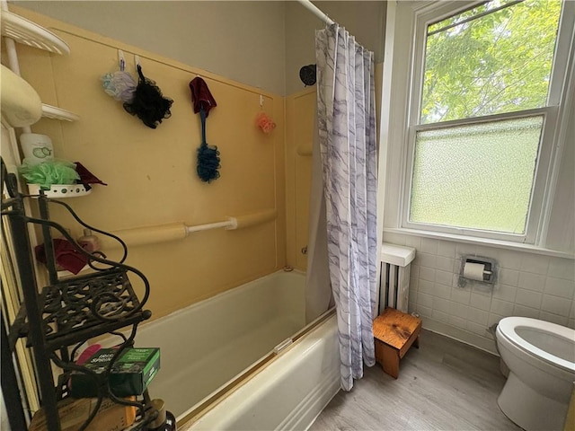 150 N Ave E, Pittsburgh, PA 15112 - bathroom featuring healthy amount of natural light, wood finished floors, shower / bath combo with shower curtain, and tile walls