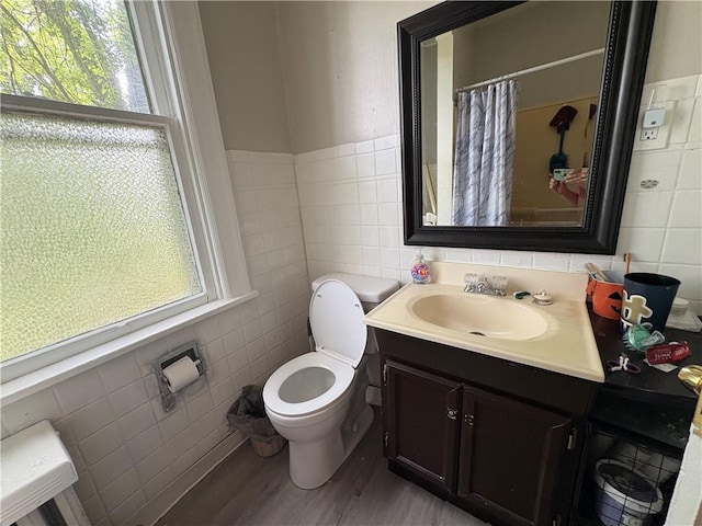 150 N Ave E, Pittsburgh, PA 15112 - full bathroom featuring tile walls, plenty of natural light, vanity, wood finished floors, and a shower with curtain