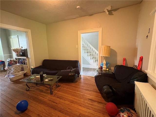 150 N Ave E, Pittsburgh, PA 15112 - living room featuring hardwood / wood-style floors, stairs, and a textured ceiling