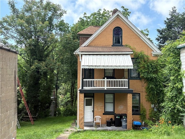 150 N Ave E, Pittsburgh, PA 15112 - back of property featuring a balcony, a yard, brick siding, a chimney, and a shingled roof