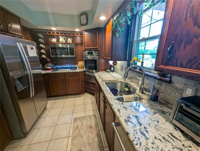 426 Unionville Rd, Franklin Twp, PA 16001 - kitchen with stainless steel appliances, tasteful backsplash, light tile patterned floors, a warming drawer, and light stone counters