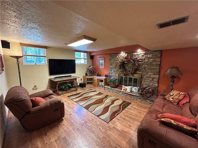 426 Unionville Rd, Franklin Twp, PA 16001 - living area featuring wood finished floors, a textured ceiling, and a large fireplace