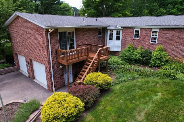 426 Unionville Rd, Franklin Twp, PA 16001 - rear view of property with brick siding, a wooden deck, stairway, an attached garage, and asphalt driveway