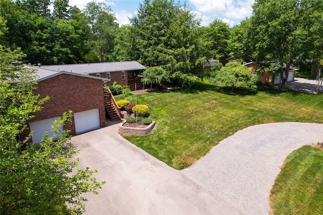 426 Unionville Rd, Franklin Twp, PA 16001 - view of grassy yard featuring stairs, driveway, and an attached garage