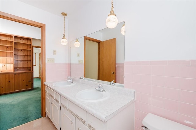 125 Jackson St, White Twp, PA 15701 - bathroom with double vanity, tile walls, and wainscoting