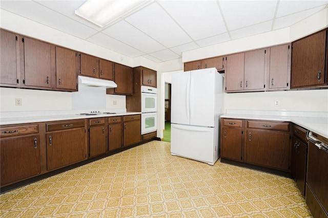 125 Jackson St, White Twp, PA 15701 - kitchen featuring white appliances, under cabinet range hood, a paneled ceiling, light countertops, and light floors