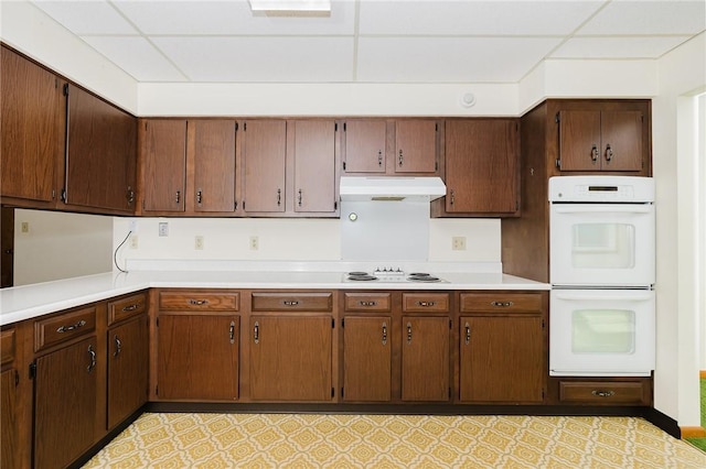 125 Jackson St, White Twp, PA 15701 - kitchen with white double oven, under cabinet range hood, and light countertops
