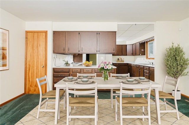 125 Jackson St, White Twp, PA 15701 - kitchen featuring light countertops, light colored carpet, and dark brown cabinetry