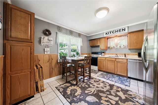 3640 Bakerstown Rd, Richland, PA 15044 - kitchen featuring appliances with stainless steel finishes, light countertops, light tile patterned flooring, crown molding, and wainscoting