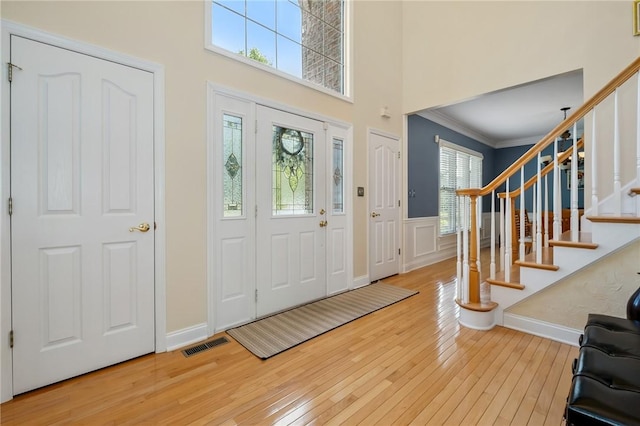 1100 Eleanor Pl, Adams Twp, PA 15044 - entrance foyer featuring hardwood / wood-style flooring, a wainscoted wall, crown molding, stairs, and a decorative wall