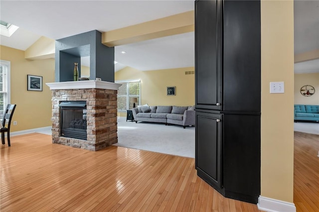1100 Eleanor Pl, Adams Twp, PA 15044 - living room with lofted ceiling, light wood-style floors, a fireplace, and a skylight