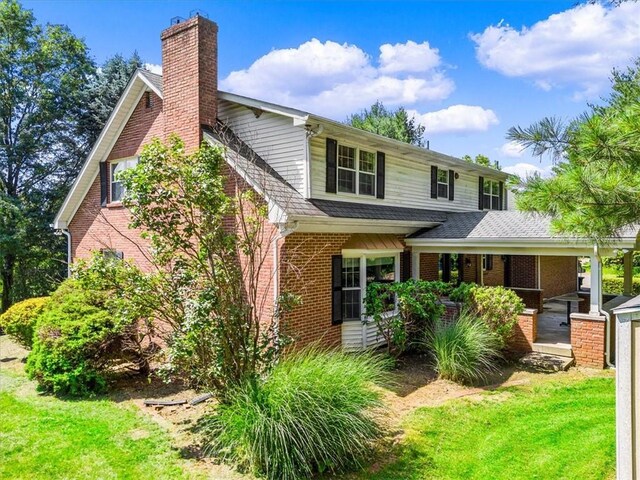 4273 River Rd, North Sewickley Twp, PA 15010 - view of front facade featuring brick siding, a front lawn, and a chimney