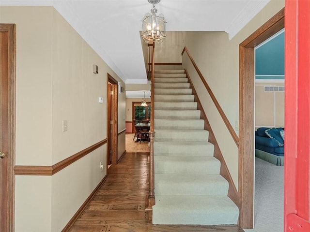 4273 River Rd, North Sewickley Twp, PA 15010 - stairs featuring a chandelier and wood finished floors