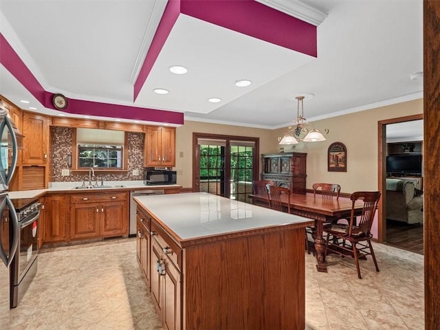 4273 River Rd, North Sewickley Twp, PA 15010 - kitchen with stainless steel appliances, brown cabinets, tasteful backsplash, a center island, and crown molding