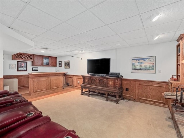 4273 River Rd, North Sewickley Twp, PA 15010 - living room with a paneled ceiling, bar with sink, wainscoting, and light colored carpet
