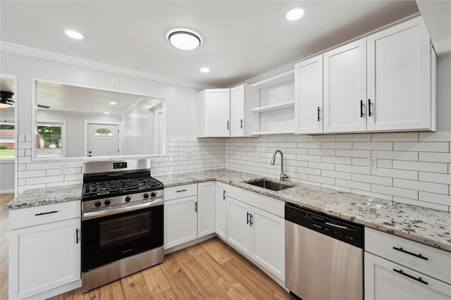 219 Sherwood Dr, Cranberry Twp, PA 16066 - kitchen with appliances with stainless steel finishes, open shelves, ornamental molding, white cabinetry, and light wood-type flooring