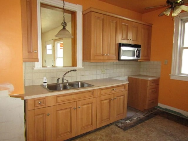 255 Duncan Ave, City Of Washington, PA 15301 - kitchen with stainless steel microwave, healthy amount of natural light, hanging light fixtures, and tasteful backsplash