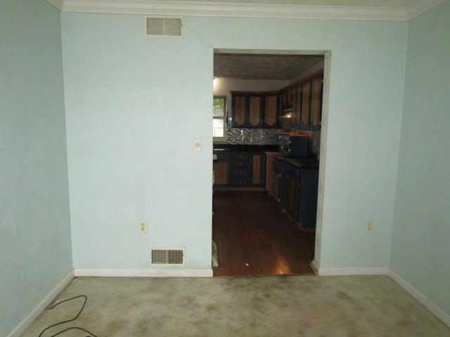 458 Wendel Rd, Hempfield Twp, PA 15642 - kitchen featuring dark carpet, ornamental molding, tasteful backsplash, and dark countertops