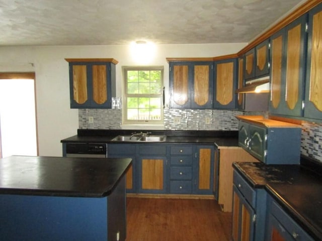 458 Wendel Rd, Hempfield Twp, PA 15642 - kitchen featuring under cabinet range hood, dark countertops, tasteful backsplash, a textured ceiling, and dark wood-style floors
