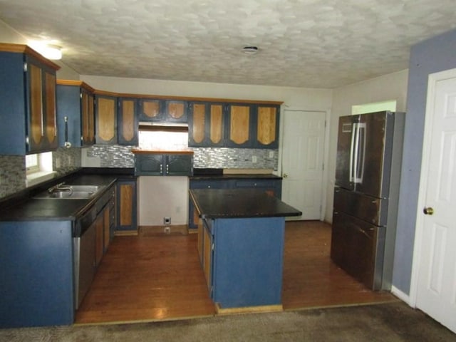 458 Wendel Rd, Hempfield Twp, PA 15642 - kitchen with appliances with stainless steel finishes, dark countertops, a center island, tasteful backsplash, and a textured ceiling