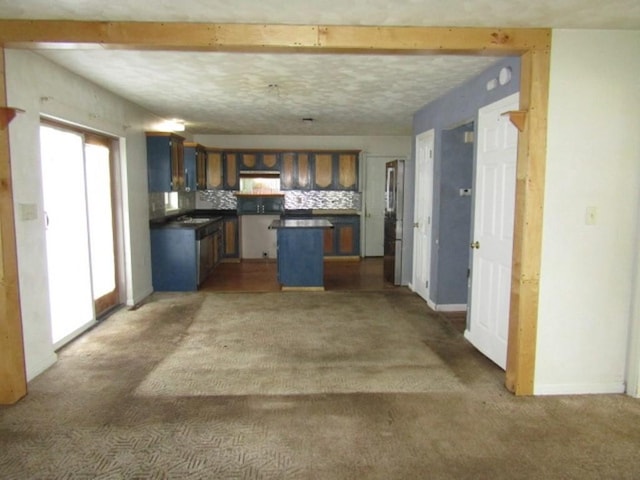 458 Wendel Rd, Hempfield Twp, PA 15642 - kitchen with dark countertops, carpet flooring, a kitchen island, and backsplash