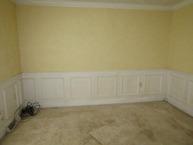 458 Wendel Rd, Hempfield Twp, PA 15642 - spare room featuring light carpet, wainscoting, crown molding, and a decorative wall