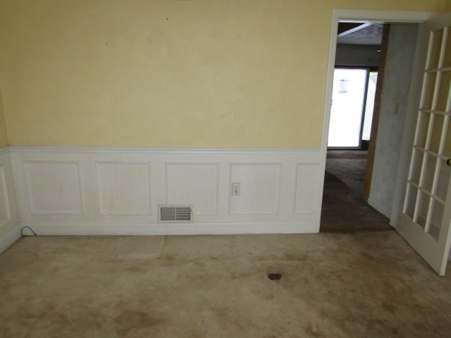 458 Wendel Rd, Hempfield Twp, PA 15642 - spare room featuring wainscoting, carpet flooring, and a decorative wall