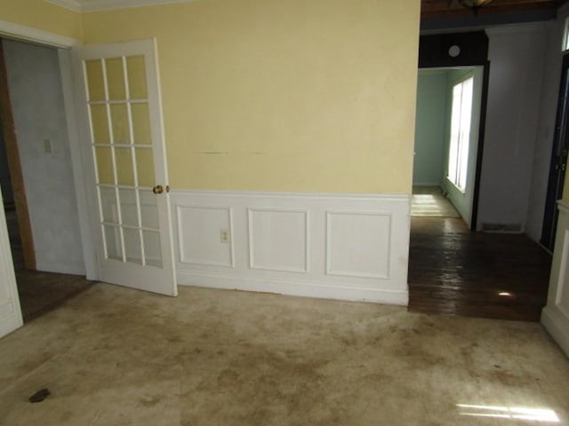 458 Wendel Rd, Hempfield Twp, PA 15642 - carpeted empty room featuring wainscoting, ornamental molding, and a decorative wall