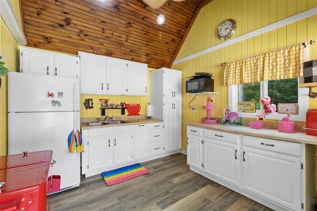207 High Acres Rd, Lancaster Twp, PA 16037 - kitchen with freestanding refrigerator, wood walls, wood ceiling, white cabinetry, and black microwave